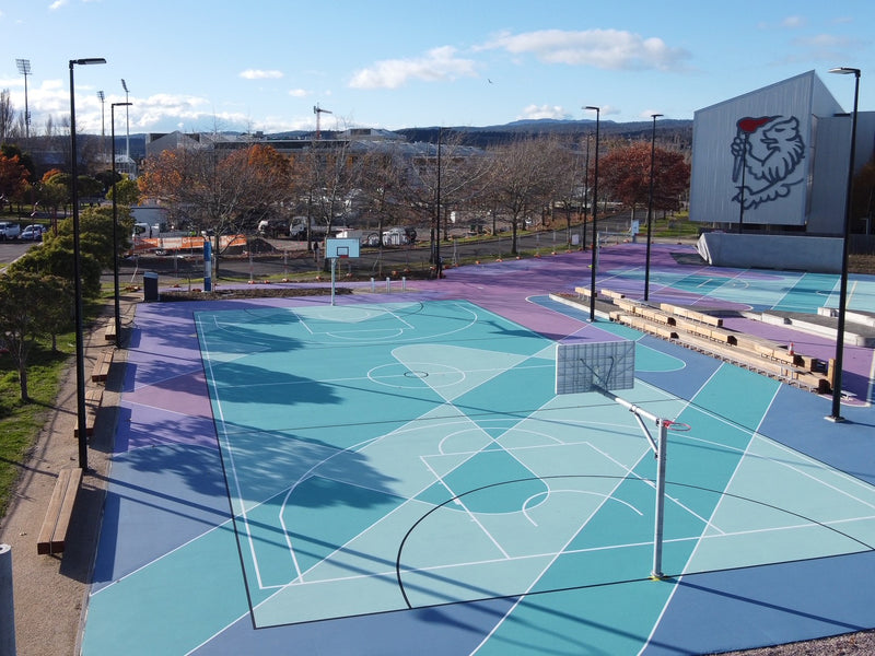 Colorful outdoor multi-sport courts with basketball hoops at University of Tasmania
